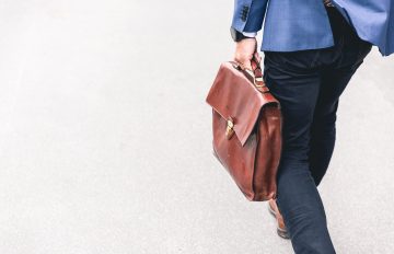 Business person carrying brown briefcase